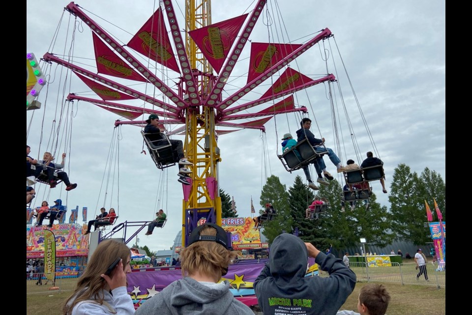 Kids enjoy the rides on the midway on Aug. 15.