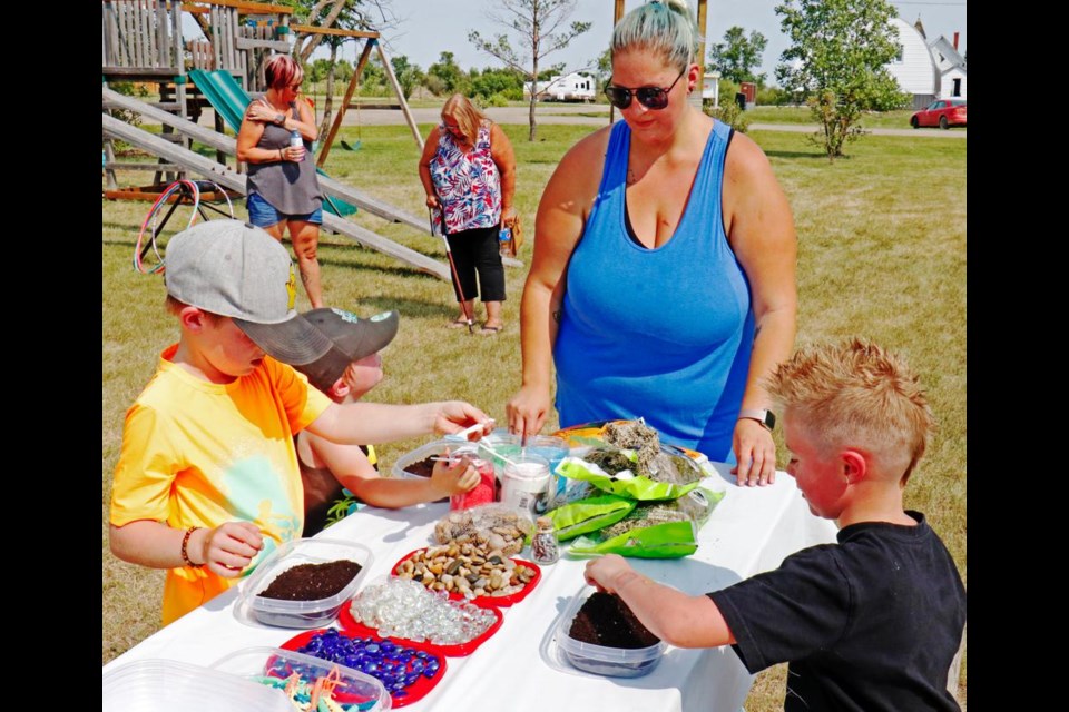 Brianna Riviere gave directions for a craft to Henry, Harrison and Asher, at one of the stations set up for family fun day in Trossachs park on Saturday.