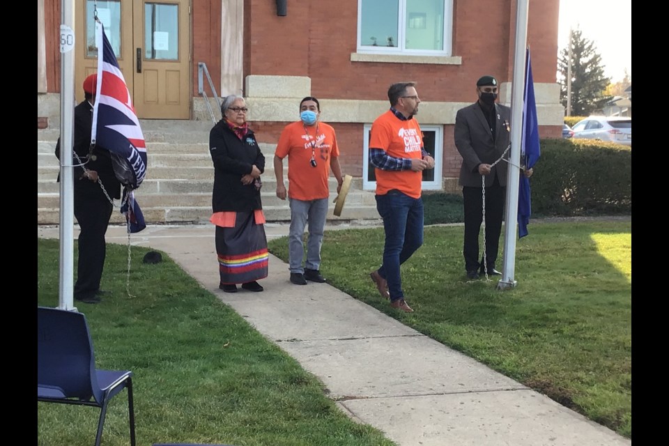 With Elder Jenny Spyglass of Mosquito FN behind, Mayor Ames Leslie presides over the raising of the Treaty 6 and Metis Nation flags at Battleford Town Hall. 