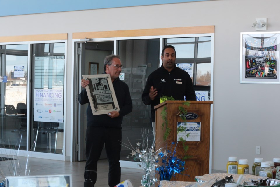 Clinton D'Souza, General Manager of Royal Honda, pictured on the right with the Silver, Green Dealer Recognition Award from Honda.