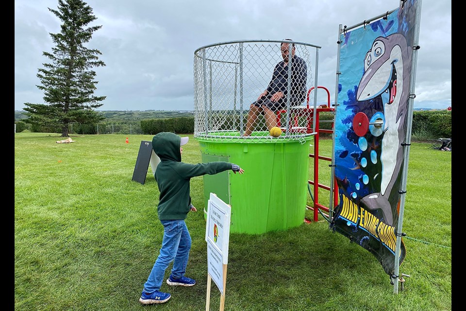 Ryan Herman looks on as Mason Pilot attempts to get Herman dunked.