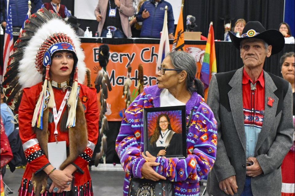 Lucille Littlefoot, centre, John Vanderkuylen, right, and FSIN Third Vice Chief Aly Bear watch dancers perform in honour of the Missing and Murdered Indigenous Women, Girls and Two-Spirit Peoples on Friday night, Oct. 21.