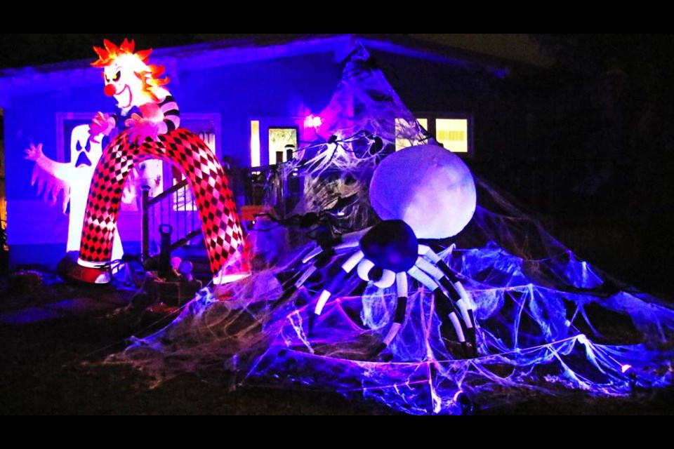 A giant spider, along with a couple of scary friends, guard this yard from any trick-or-treaters who would dare to venture out on Halloween night.