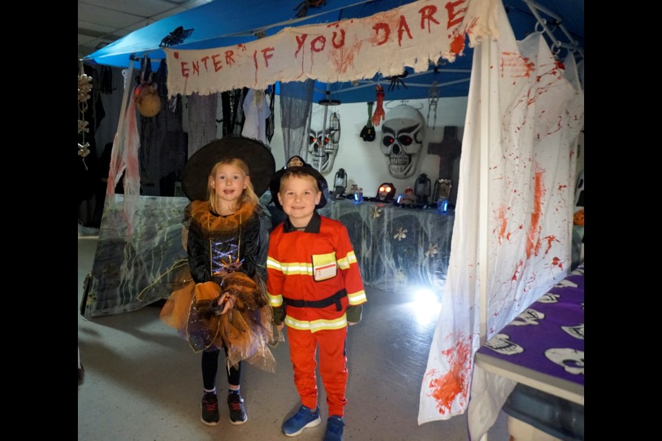 Little witch Olivia Ursu and firefighter William Ciepliski explored the Estevan Public Library's haunted house. 
                            
