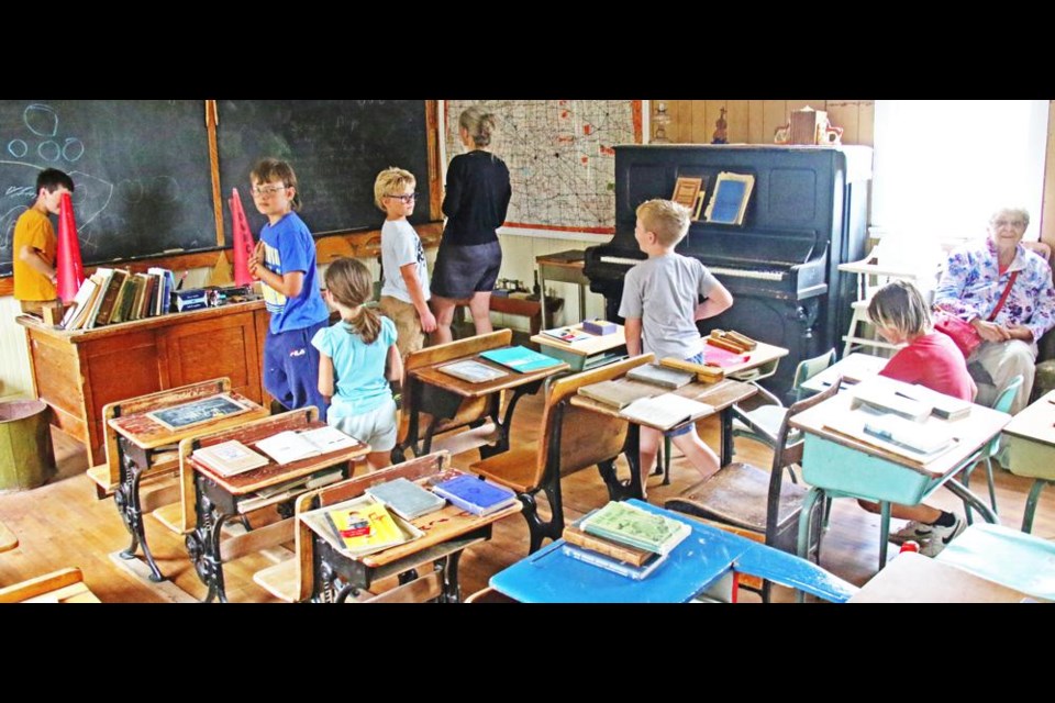 Meadow Brook School had many visitors during Heritage Village Days, including students curious about what a long-ago school room looked like.