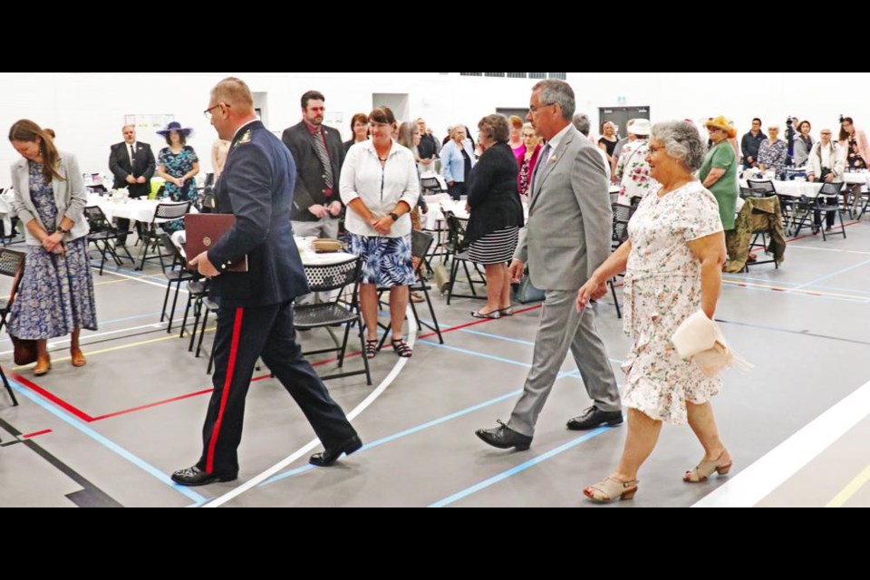 Aide Rod Stafford led in Lieutenant-Governor Russ Mirasty and his wife Donna to the Legacy Park School gym for the High Tea event on Saturday.
