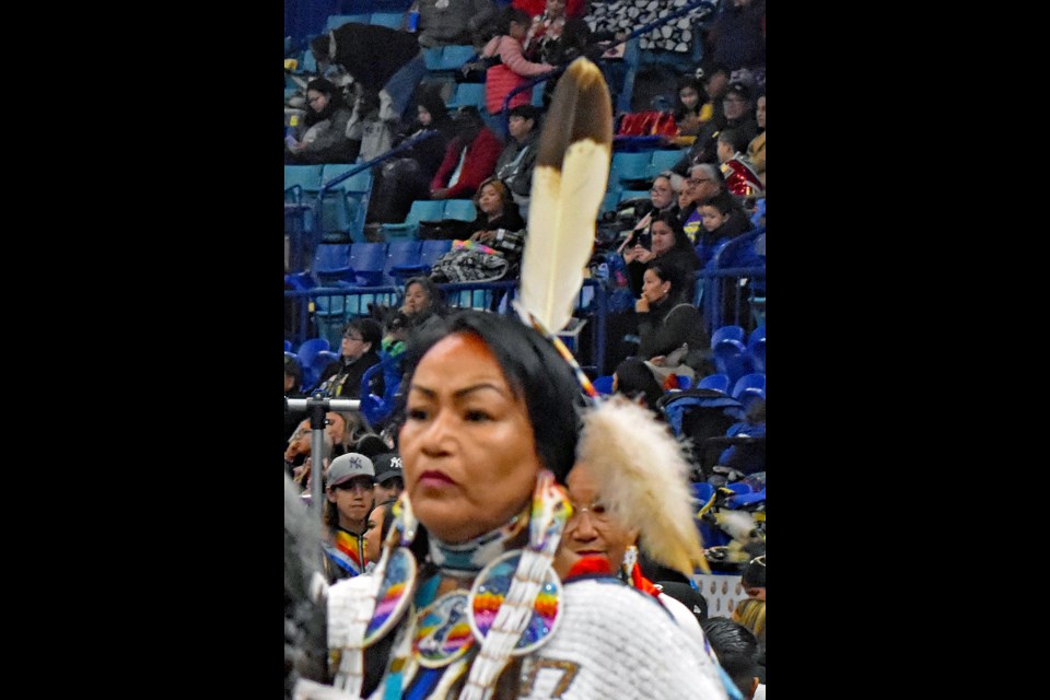 An Indigenous woman participates in a powwow event.
