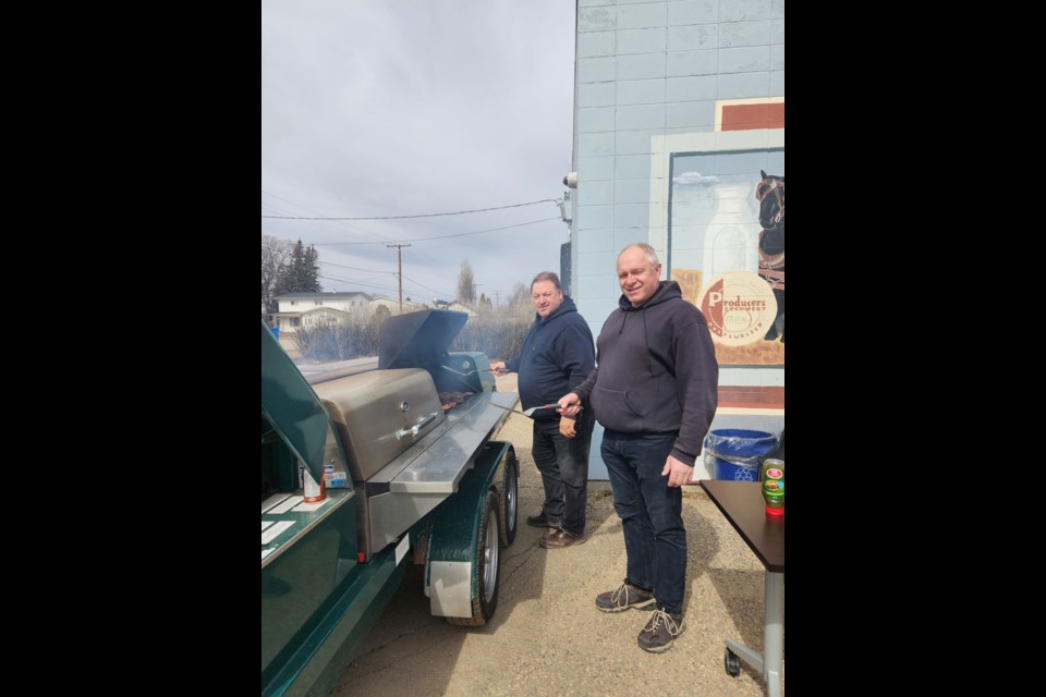 Nutrien employees Lindsay Gampe and Darren Stifter brave the cold weather manning the barbecue for a Nutrien initiative to benefit Unity's KidSport.