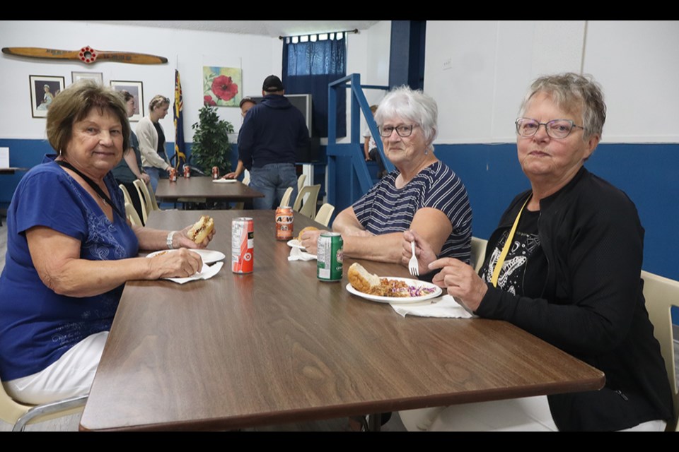 Enjoying their lunch of pork and beans, coleslaw, pulled pork, buns and a drink at the Legion Dugout on Aug. 15, from left, were: Bev Fransishyn, Monica Dudeck and Sharon Ciesielski.