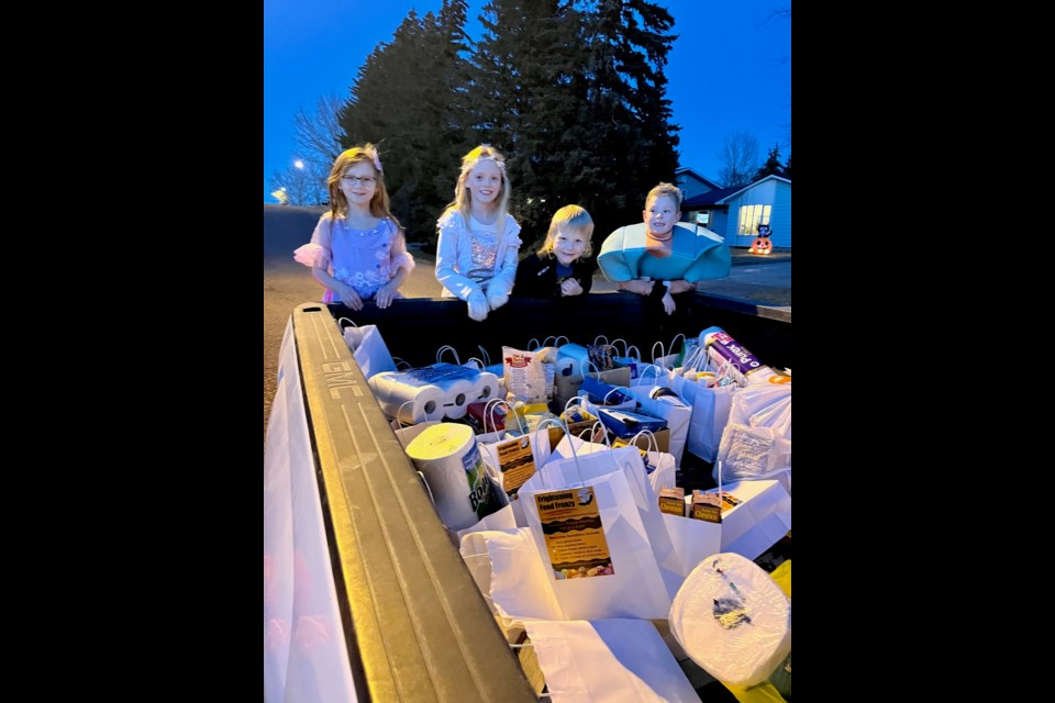 Saydee, Carmen, Jace and Dane joined multiple volunteers who collected food donations Halloween night in Luseland.