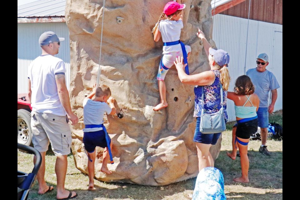 Children tried their hand at a climbing and rappelling wall, set up in MIdale's Heritage Village as part of the Pioneer Echoes event over the August long weekend in 2022.