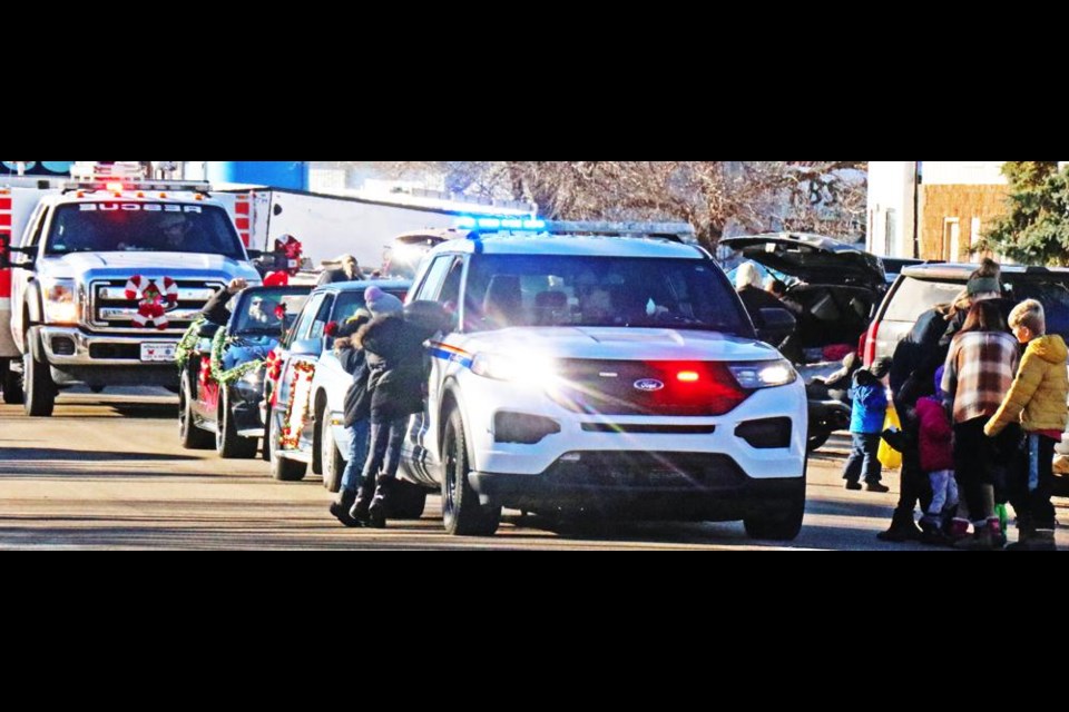 The RCMP cruiser, in the lead of Midale's Santa Parade, invited kids to come over and get a treat at the start of the parade on Main Street.