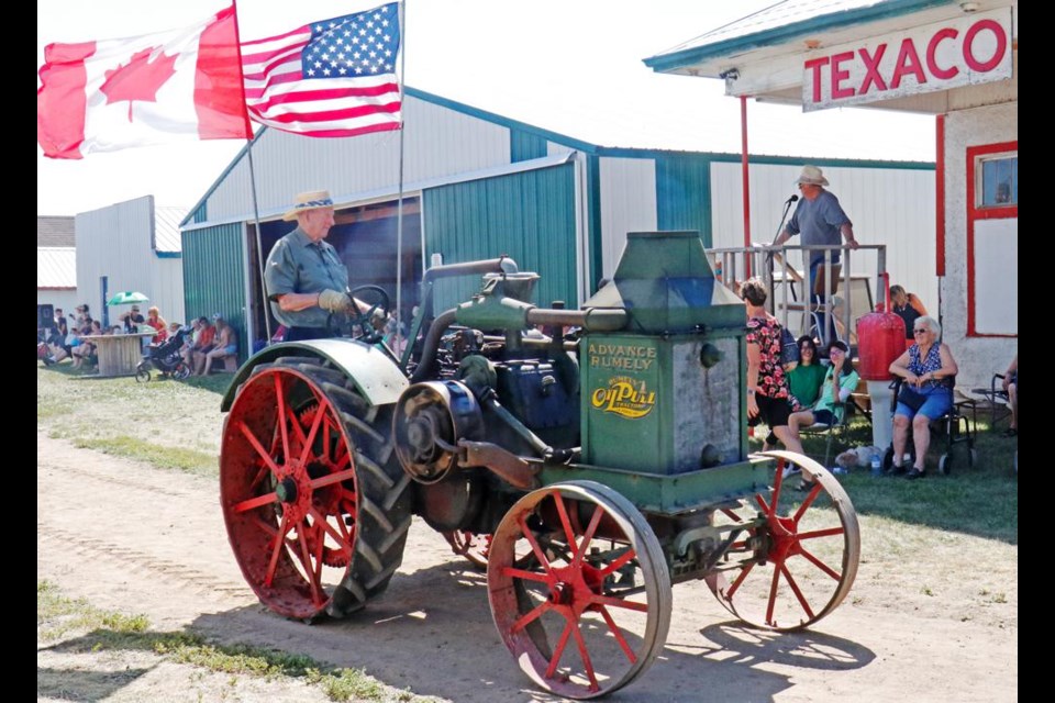 The lead-off tractor for Midale's antique tractor parade at the Heritage Village drove by the announcer's booth.