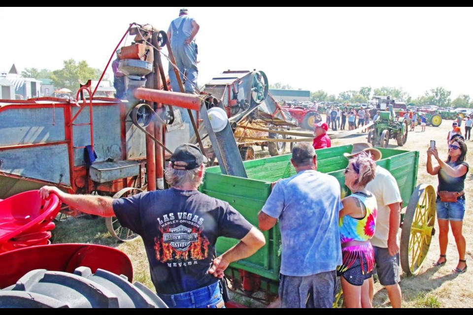 A Case 22-36 threshing machine, ca 1925, was used to thresh wheat, powered by a 1917 Mogul tractor powering it with a belt, at Midale's threshing demonstration on Saturday.