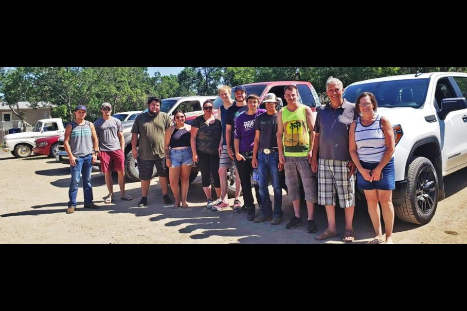 The exhibitors at a small car show at the Midtown Care Home gathered for a group photo.