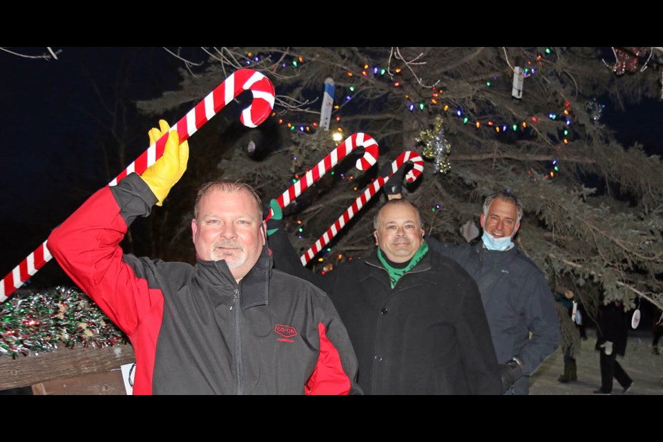 Humboldt and District Chamber of Commerce president Brent Walker, mayor Michael Behiel, and downtown business improvement district president Jamie Richardson throw on the Christmas Tree lights at the chamber campground to launch the 2021 edition of Moonlight Madness.