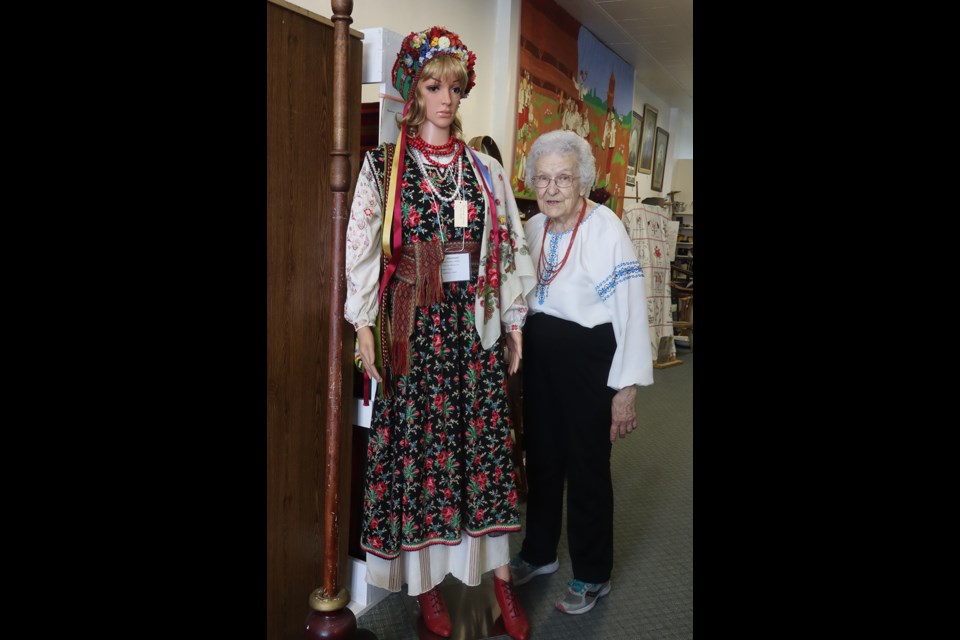 At the Canora Ukrainian Heritage Museum open house on July 10, Dorothy Korol, volunteer, stood next to one of the new mannequins that display authentic Ukrainian clothing.