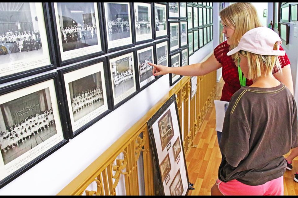 Museum staff member Teagan Dubiel explained to Marlie Cleator these were photos of graduating nurses from the old Weyburn Mental Hospital from the 1930s, 40s and 50s.