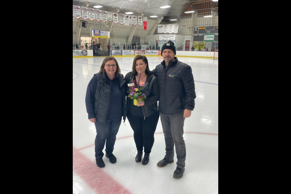 Representing Unity Skating Club, Michelle Brown-McLean, stands with Nicole Headrick and Unity Minor Hockey president and ball coach Dan Feser at a special presentation made April 12.