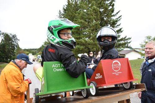 Jake Johnson, left, paired with Liam Kish to see whose box car would be first to cross the finish line at the end of the closed off street in Norquay.