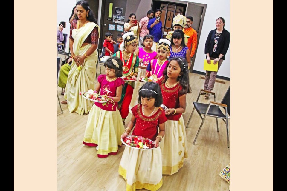 Children, dressed in traditional costume dress from India, entered holding Thaalapoli (a tray with a lamp) on either side, along with special guest Coun. Laura Morrissette from city council, to start off the Onam festival on Saturday.