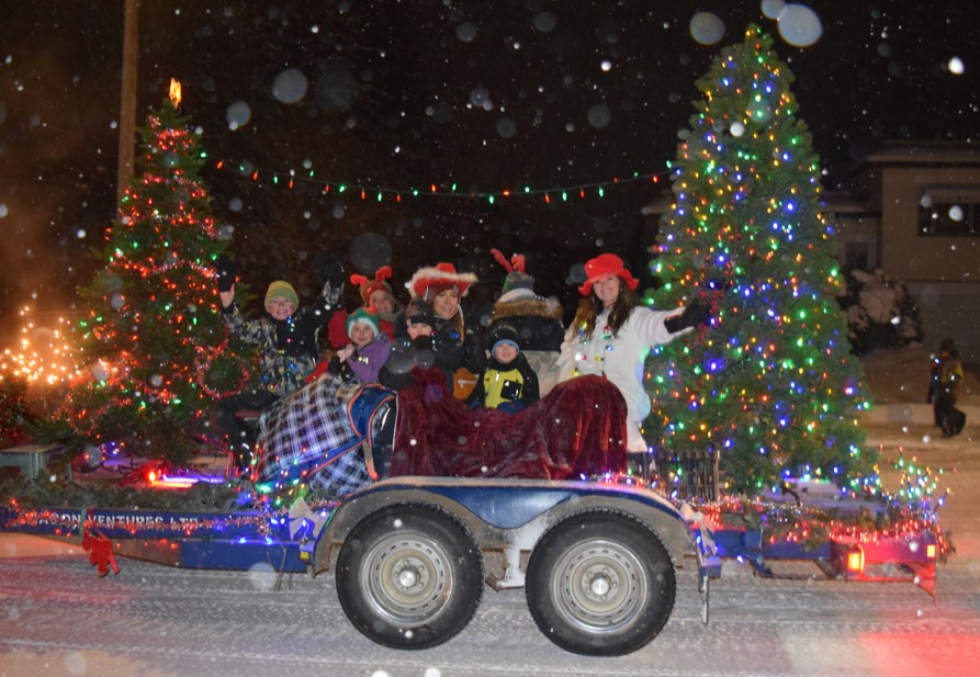 Parade participants, including Canora Tourism Fundraising Committee members and their children on this float, were bundled up against the cold and snow for the Winter Lights Festival Parade on Dec. 1. Large numbers of spectators braved the wintry conditions to enjoy the parade as well as the other events during Winter Lights Festival week. See the special Christmas edition for compete coverage.
