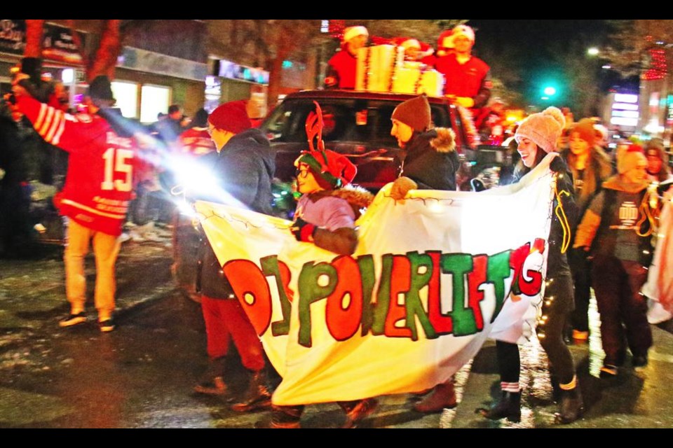 The players for the Weyburn Gold WIngs and Red WIngs teams carried banners and circled their float during a break in the Parade of Lights last year.