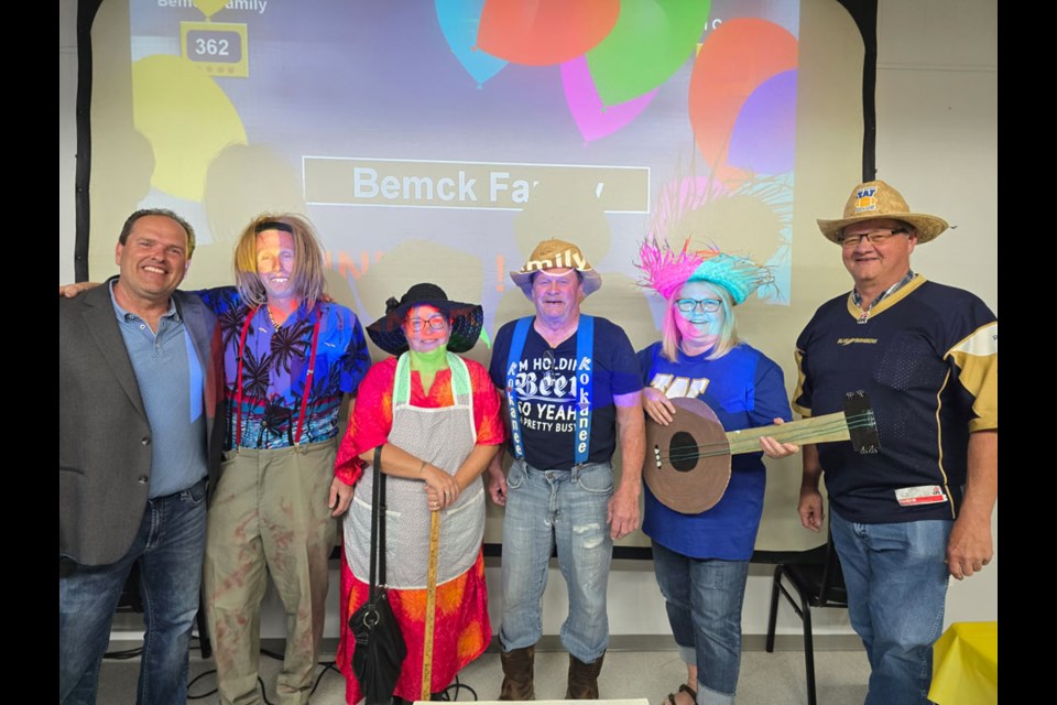 The BEMCK family, winners of the Family Feud, along with MC Trevor Kerr. 
