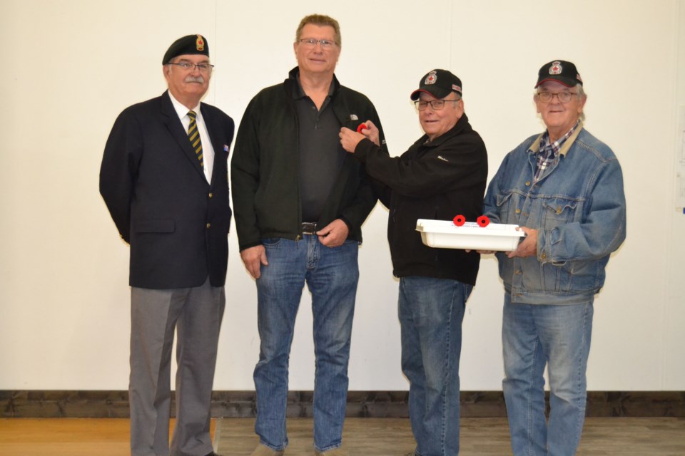 The Preeceville Legion kicked off its Poppy Blitz with selling the first poppy to Preeceville Mayor Ralph Ager on October 27. Photographed from left, were: Bill Lesko, Legion president, Ager, Blaine Medlang, Legion Poppy chair and Phil Murrin.