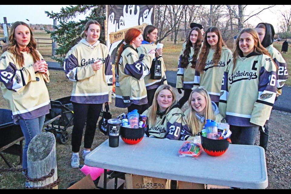 Players from the Weyburn Gold Wings helped to welcome visitors to Pumpkin Lane on Saturday evening.