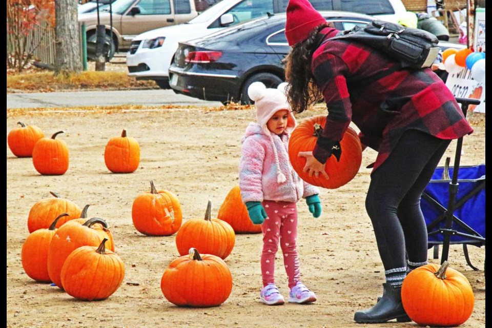 A little girl was shown a pumpkin by her mom for buying from the "Pumpkin Patch" on Saturday, a fundraiser held by the Weyburn Co-operative Playschool.