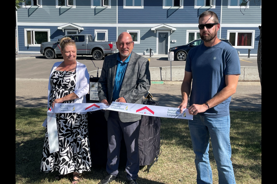 Shelly Christian, general manager of the RHA, on the left, Terry Jenson, Minister Responsible for Saskatchewan Housing Corporation (SHC), in the middle, and others help reveal the six newly upgraded units at Regency Gardens.