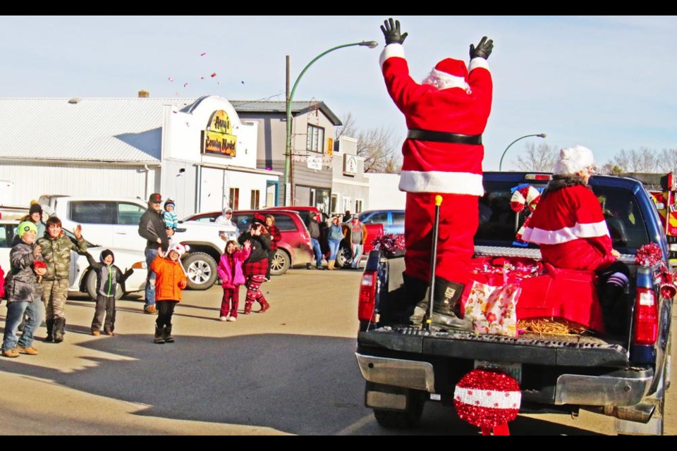 Santa Claus waved at families and children as he and Mrs. Claus were the final float in Midale's Santa parade on Saturday.