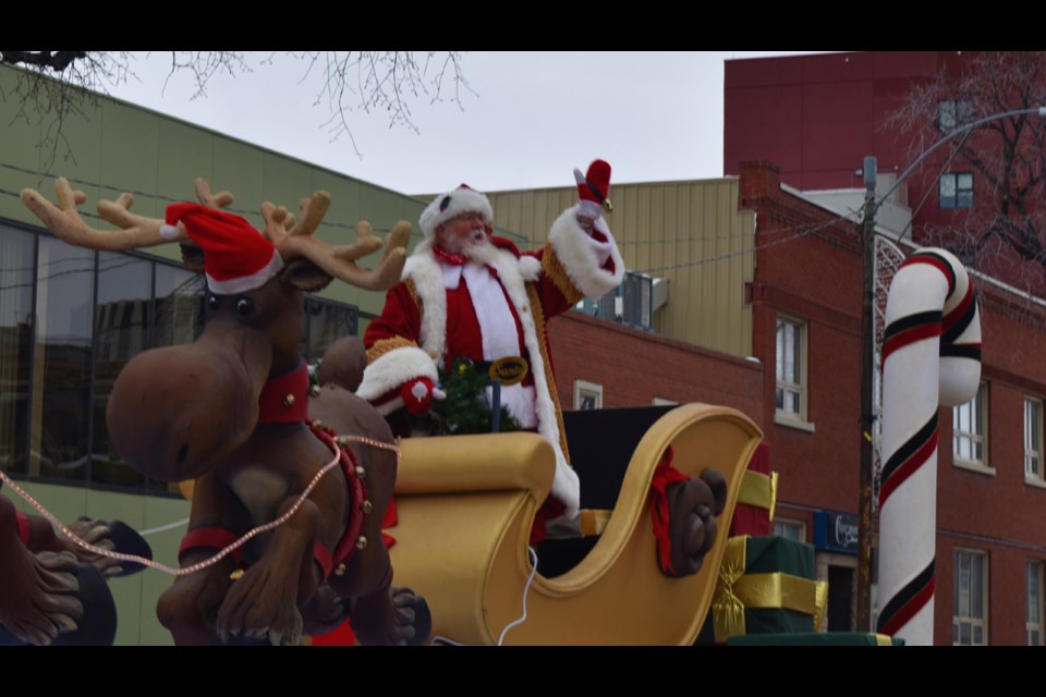Santa Claus, the main event of Sunday's parade, waves to the crowd.