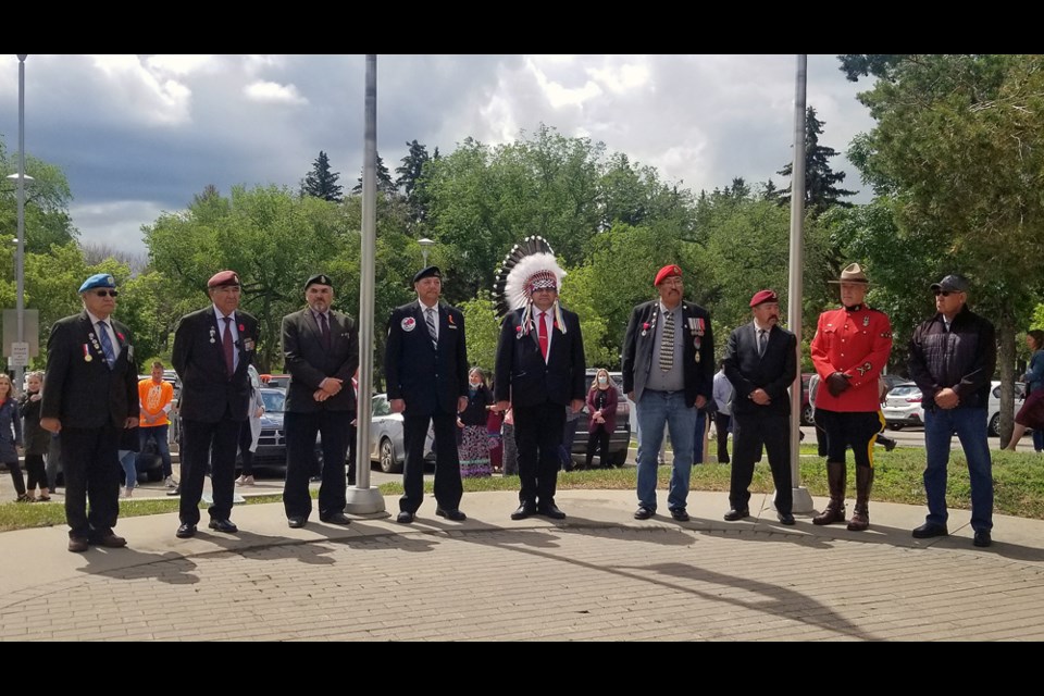 Saskatchewan First Nations Veterans Association members, led by Grand Chief David Raymond Gamble, center, pose for photos after the Truth and Reconciliation flag-raising ceremony at the Saskatoon City Hospital.