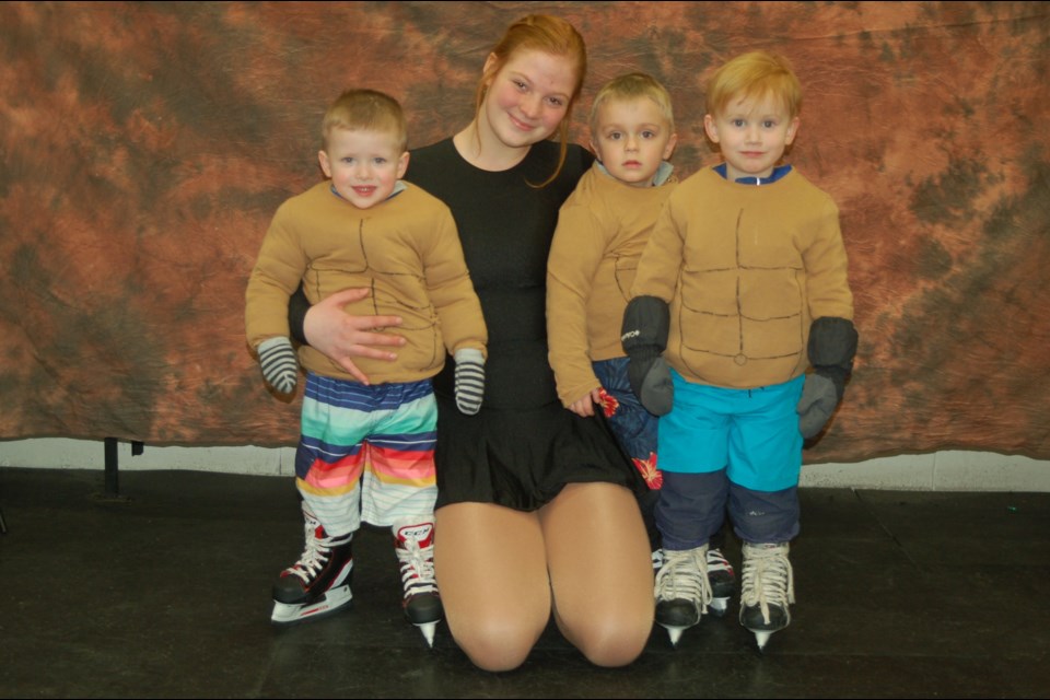 Showcasing their surfing skills, from left, were: Deklyn Morton-Blender, Mollie Jaeb (assistant), Everett Nelson and Forrest Van Nieuwenhuyze.