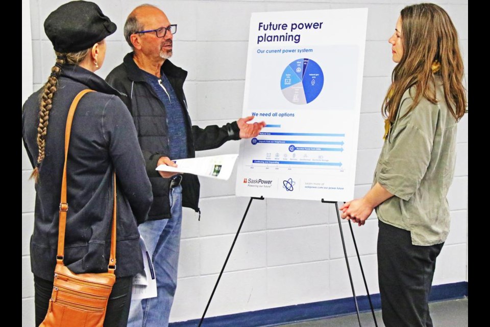 Weyburn residents Alice Neufeld and Jack Jones talked with Alexis Doyle, a SaskPower representative, at a drop-in meeting on nuclear power plans in the province, held on Friday at the Weyburn Leisure Centre.
