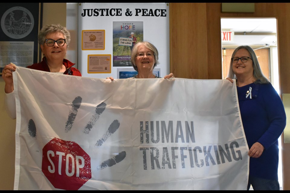 Human Trafficking Awareness Project co-chairs Ashley Ashcroft, from left, and Donna Aldous with St. Anne Parish Catholic Women's League Council President Pat Ballantyne.