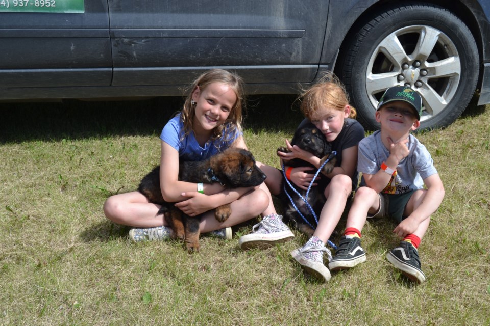 Paws and Claws had a few dogs up for adoption at the Sturgis Sports weekend. Getting in some puppy cuddles from left, were: Cruz Jaeb and Georgia and Forrest Van Nieuwenhuyze.