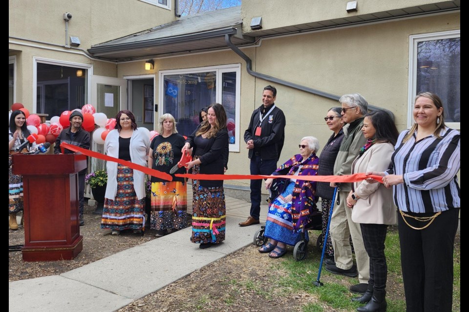 Miyo-mahcihoyān Transition House executive director Christine Daniels cuts the ribbon to formalize the facility's grand opening.