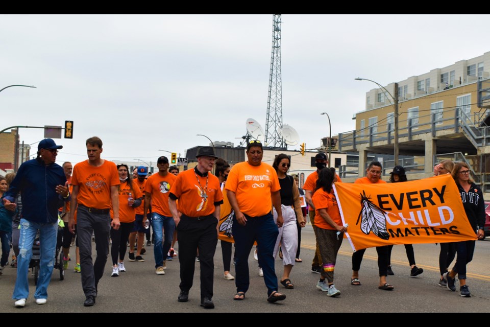 Saskatoon Mayor Charlie Clark, second from left, joins Diocese of Saskatoon Bishop Mark Hagemoen and Saskatoon Tribal Council Chief Mark Arcand in last summer's Truth and Reconciliation Commission Calls to Action Awareness and Education Walk in the city's downtown area.