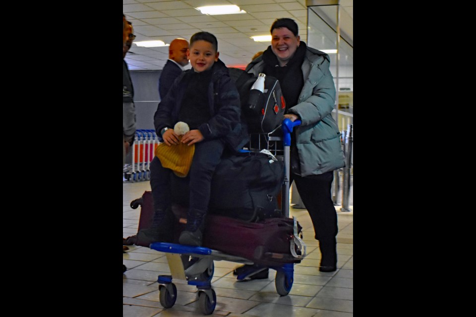 A Ukrainian mother and her son are all smiles after arriving in Saskatoon.