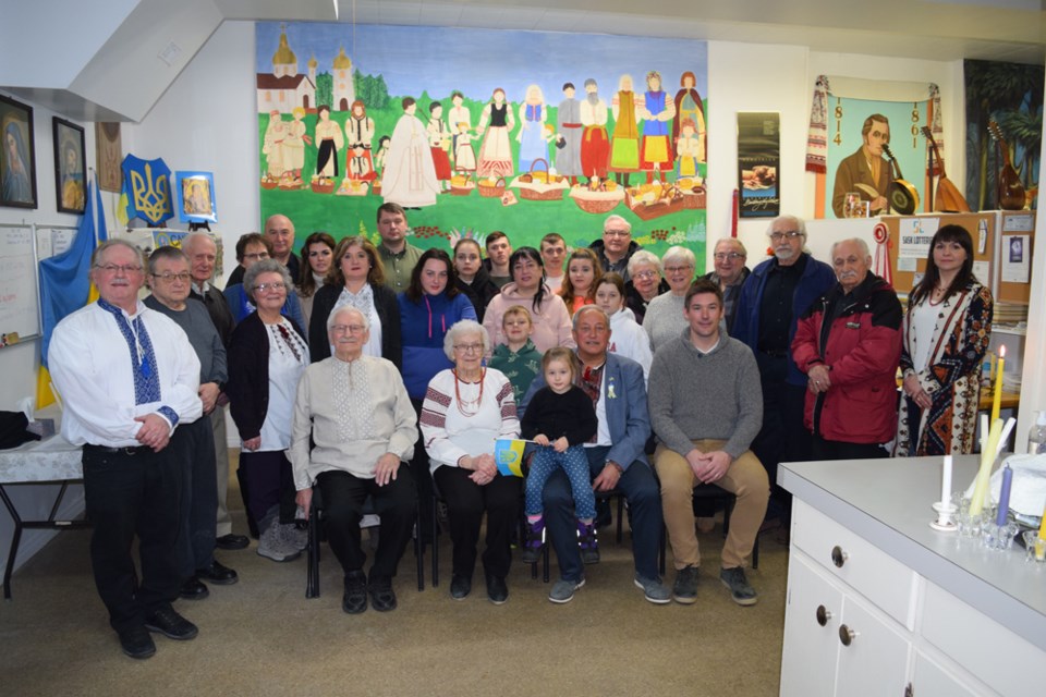 All those in attendance at the candlelight vigil at the Ukrainian Heritage Museum to show support for Ukraine on the one-year anniversary of the Russian invasion gathered for a group photo. 