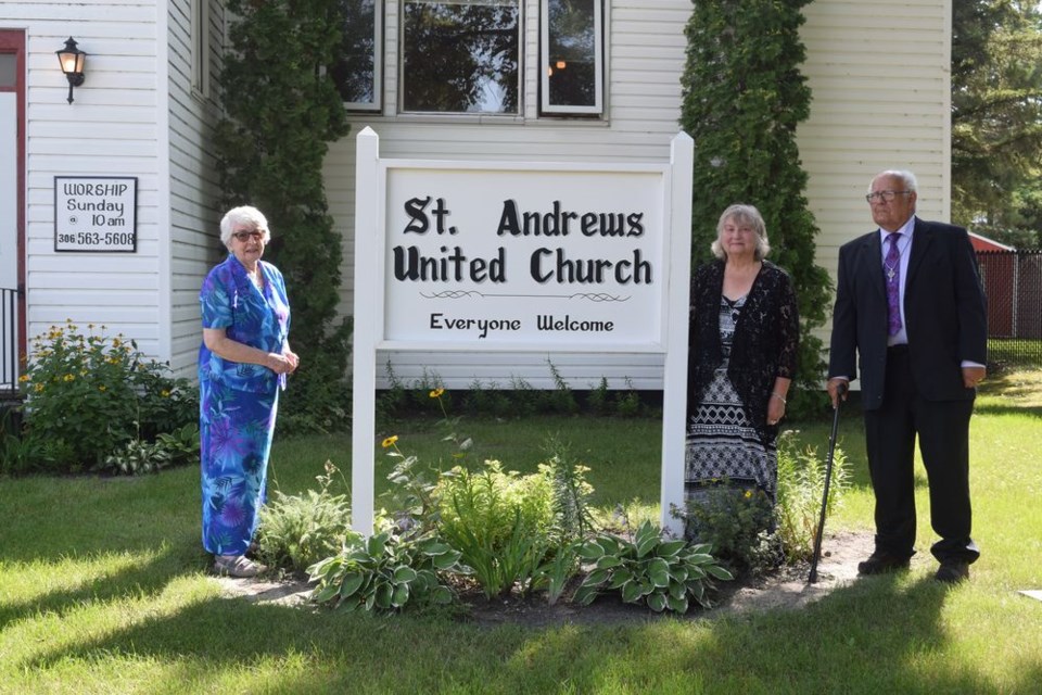 Parishioners of St. Andrews United Church of Canora have spruced up the church exterior with a pair of new signs. The signs were designed by Bill Slowski of Canora and funds were raised through church member donations. The sign dedication took place on Sunday Aug. 21. From left, were: Joy Stusek, Val Morozoff and Pastor Thom Carnahan.