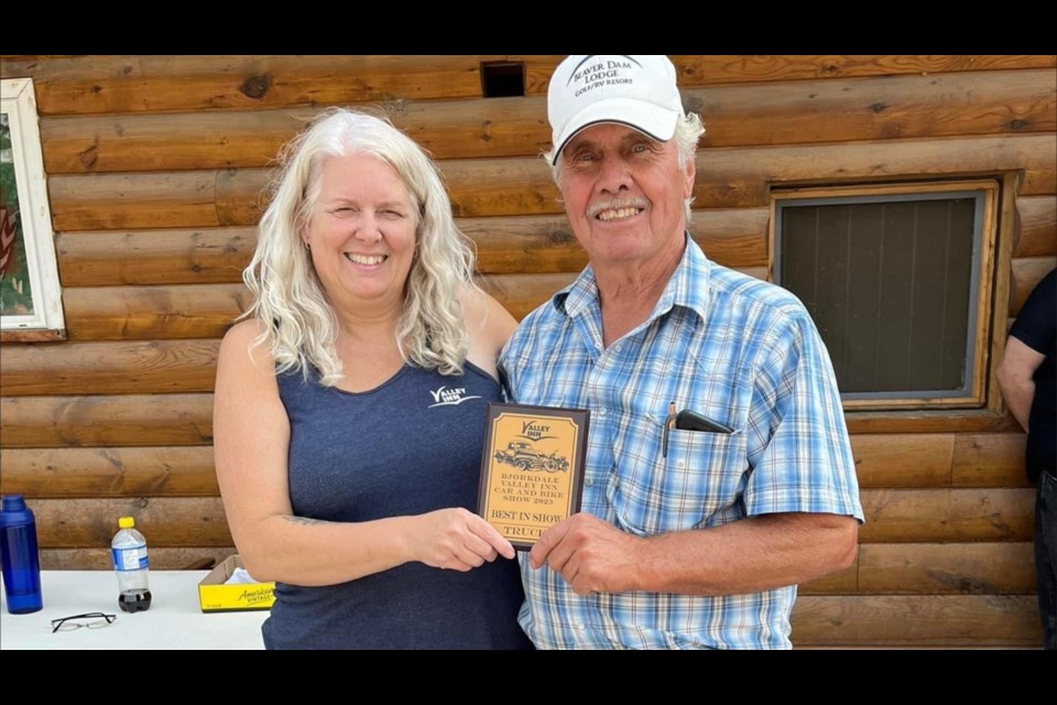 Bob Jackson, right, received first place in the top truck category at the Valley Inn's annual show and shine.