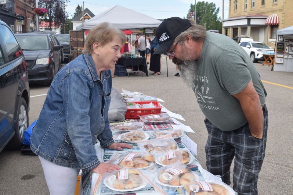 Del Palagian of Canora brought her homemade foods to share with customers. Kevin Krotenko was one of many to stop by to find out what she had to offer, which included: perishke, raspberry cinnamon buns, beetniks, and polish and garlic sausage.