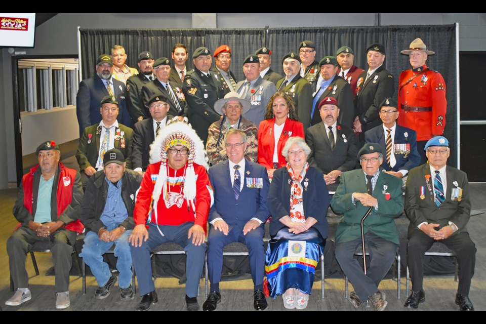 Some of the veterans who were the recipients of Queen Elizabeth II's Platinum Jubilee medal join Lt.-Gov. Russell Mirasty, centre, and Federation of Sovereign Indigenous Nations Second Vice Chief Edward "Dutch" Lerat, third left, after the ceremony.