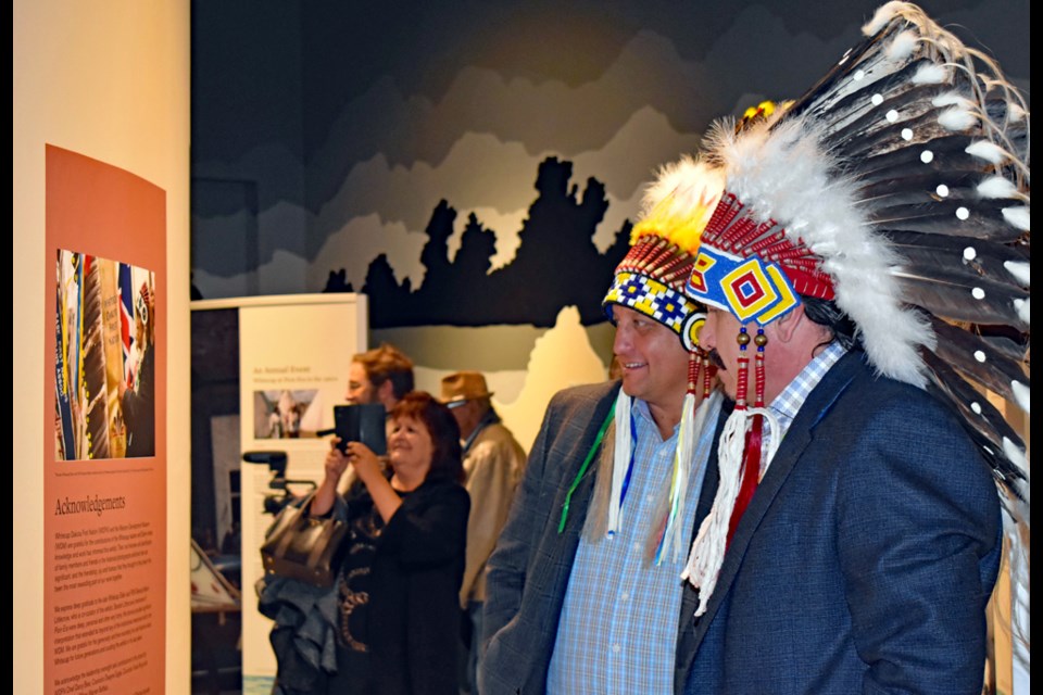 Saskatoon Tribal Council Chief Mark Arcand, left, and Whitecap Dakota First Nation Chief Darcy Bear enjoy looking at the exhibit.
