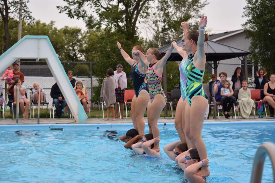Lifeguards at the Wilkie Community Swimming Pool wow the audience with their synchronized swimming routine as part of the their annual Water Show.