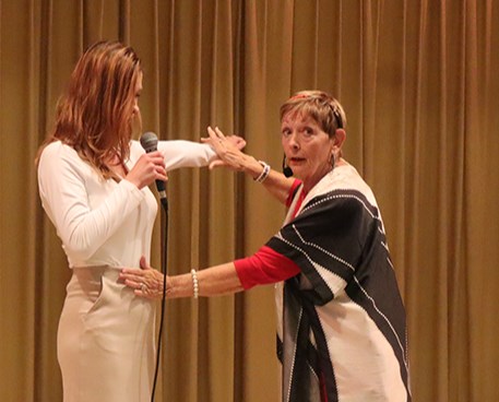Dr. Rose Backman (right), drawing on 35 years of experience in the field of kinesiology, performed a physical assessment on a volunteer from the audience.
